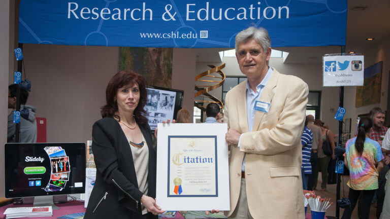 photo of Bruce Stillman holding a Citation