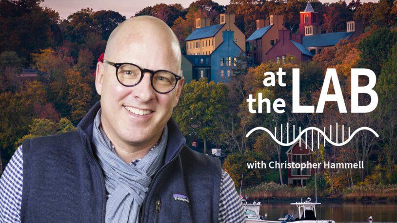 image of Cold Spring Harbor campus from across the harbor with At the Lab podcast logo and portrait of Christopher Hammell