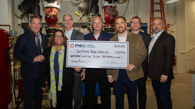 photo of Brandon King presenting CSHL with a check from PSEG