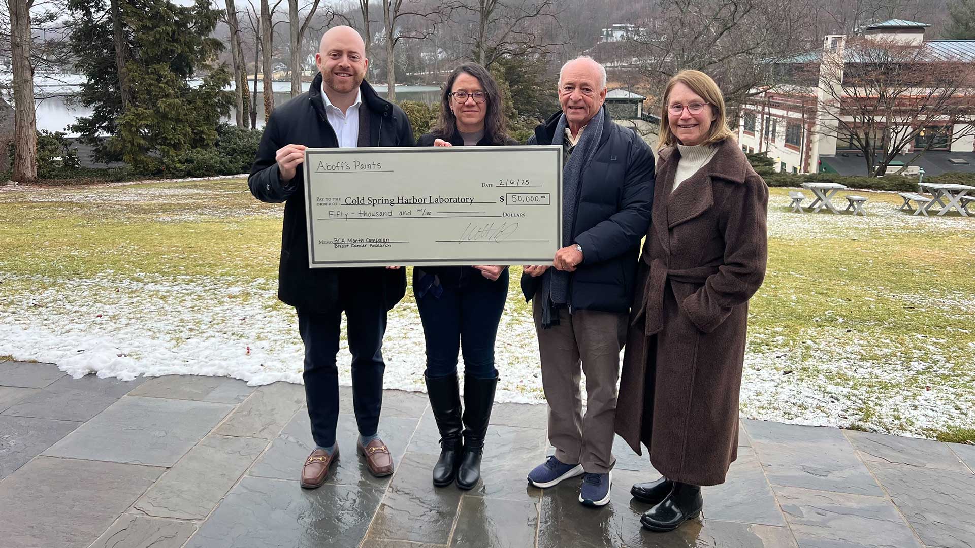 photo of Aboff paints presenting a check to Camila dos Santos